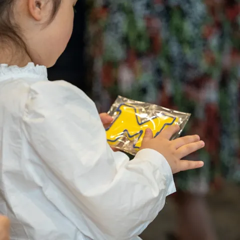 Kid holding M cookie